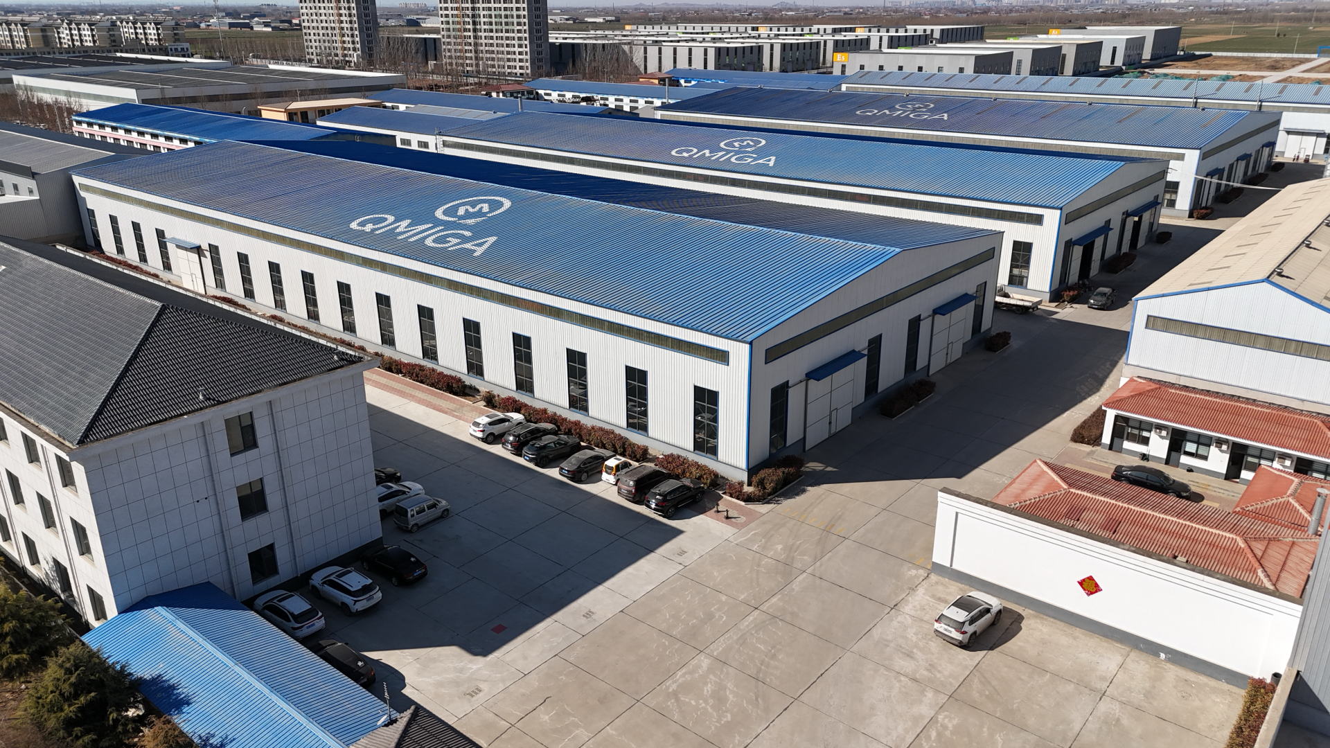 Modern factory interior with automated assembly line producing electric forklifts, blue painted walls and yellow safety lines on concrete floor